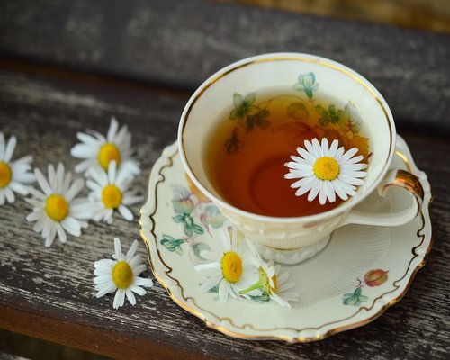 Cup of herbal tea resting on a wooden table