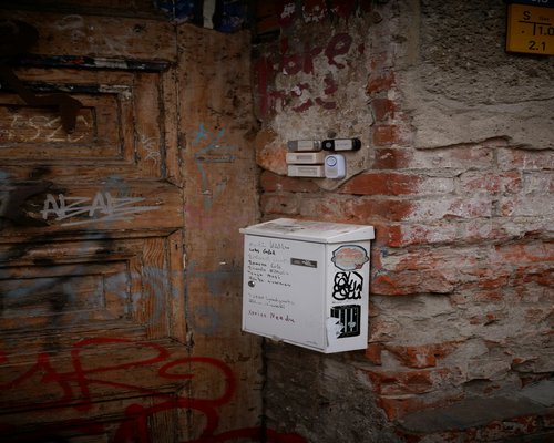 A classic letterbox attached to an old brick wall in Berlin