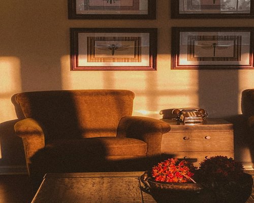 A cozy dimly lit living room with a comfortable armchair